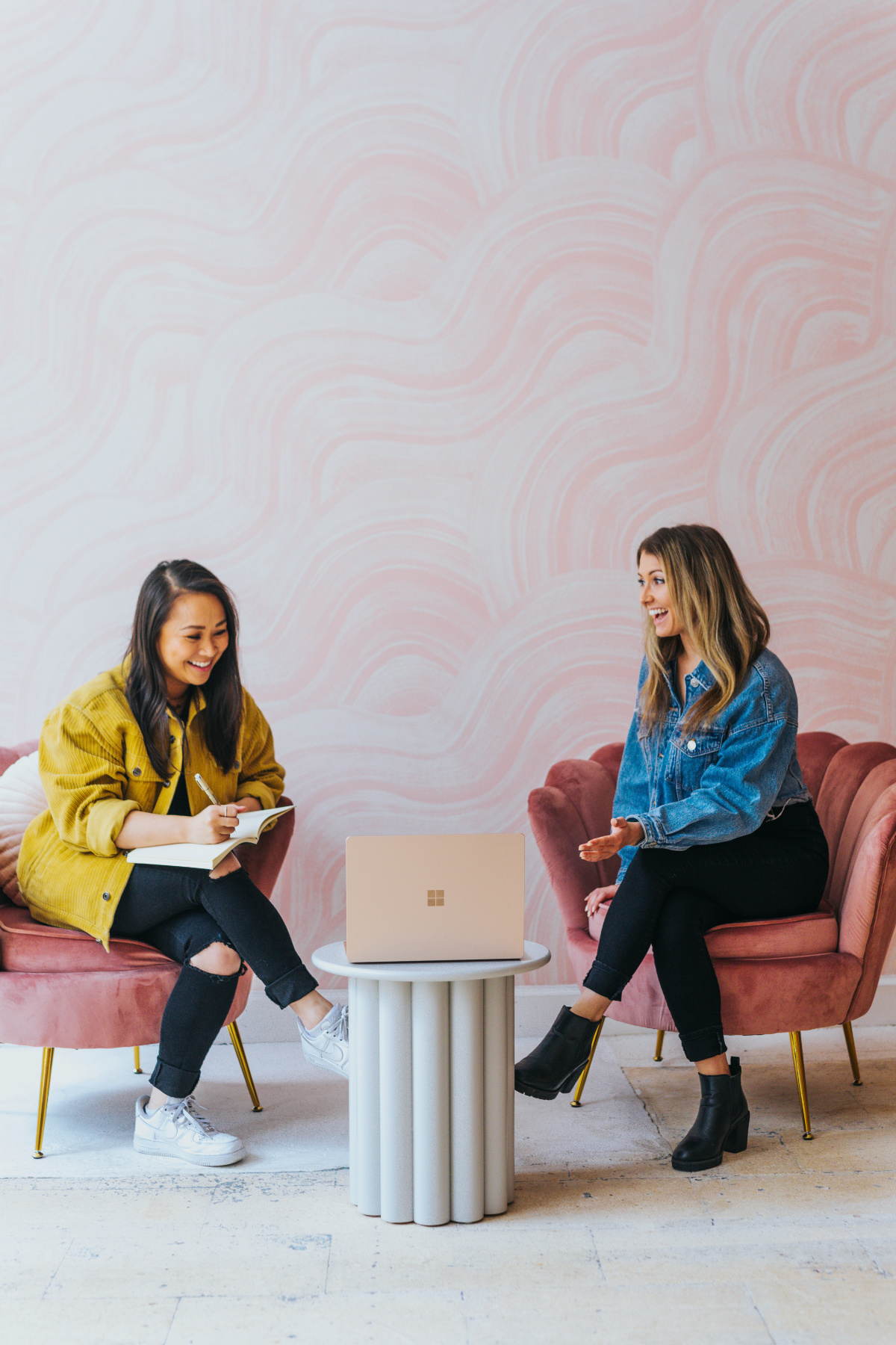 Two wome sitting in chairs and talking